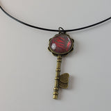 Red, Green, and Tan Key-Shaped Pendant